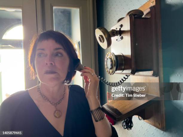 mature woman talks on old retro telephone - malta culture stock pictures, royalty-free photos & images