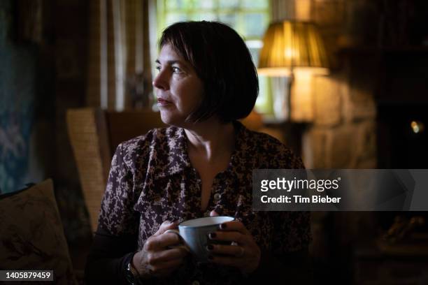 mature woman drinking. - old lady at home stock pictures, royalty-free photos & images