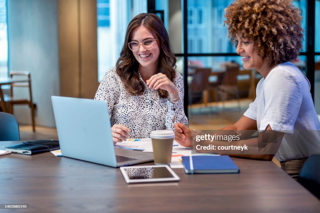 Business colleagues working together on a laptop