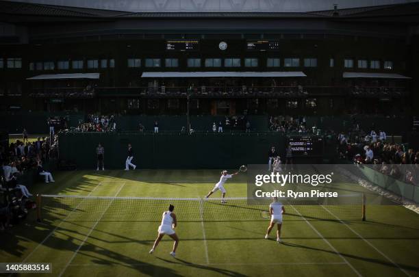 Monica Niculescu of Romania plays a volley alongside her partner Elena Gabriela Ruse of Romania during their Women's Doubles First Round match...