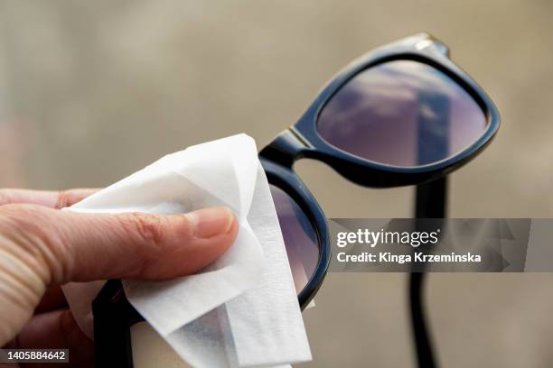 cleaning sunglasses - aesthetic medicine stock pictures, royalty-free photos & images