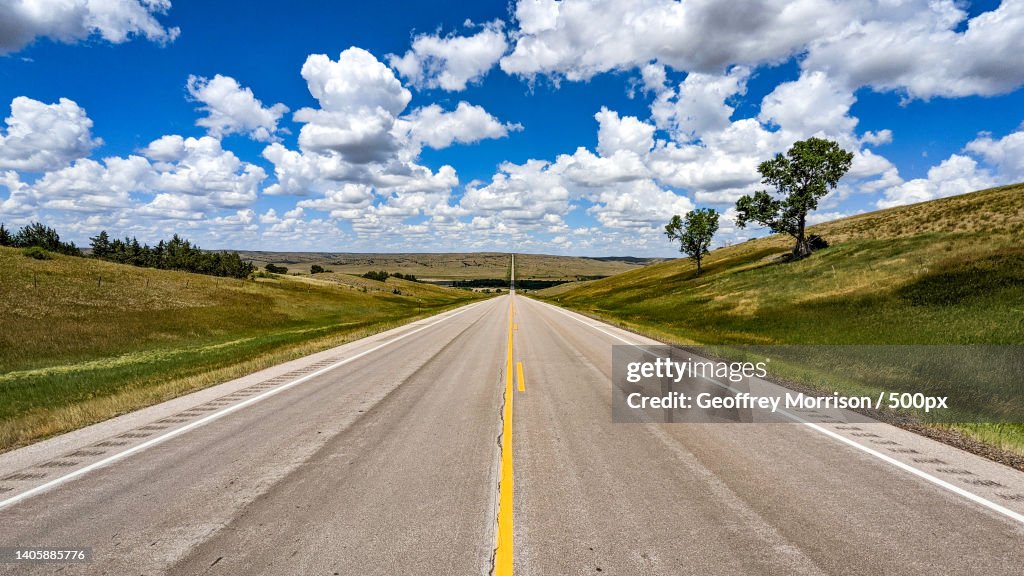 Empty road amidst field against sky,South Dakota,United States,USA