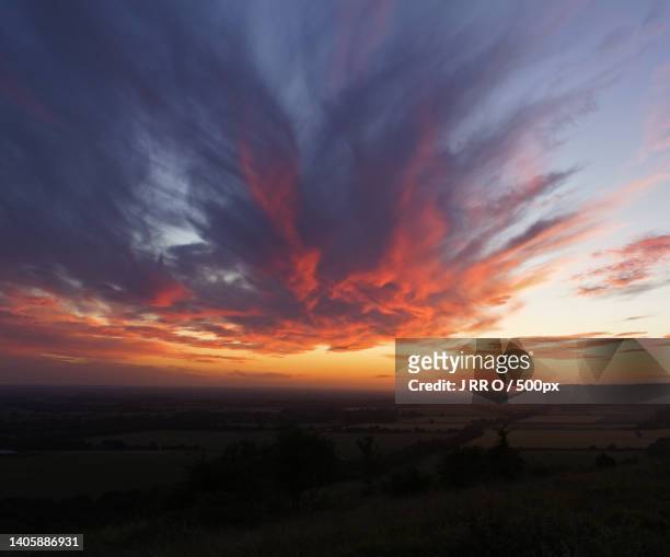 streaking red clouds over dark land,chiltern hills,united kingdom,uk - images stock pictures, royalty-free photos & images