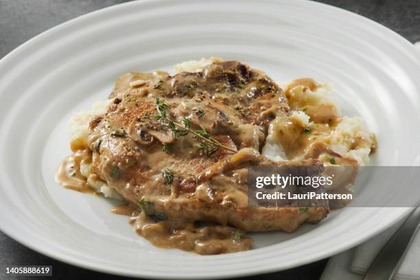 braised pork chops in creamy mushroom sauce - gravy stock pictures, royalty-free photos & images