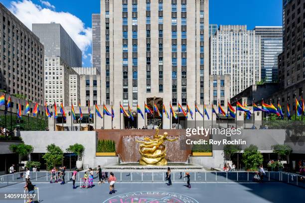 Pride flags are displayed behind the "Prometheus" statue in the center of Rockefeller Plaza with "30 Rock" behind it on June 29, 2022 in New York...
