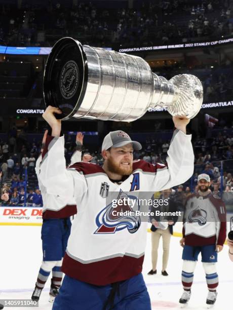 Nathan MacKinnon of the Colorado Avalanche carries the Stanley Cup following the series winning victory over the Tampa Bay Lightning in Game Six of...