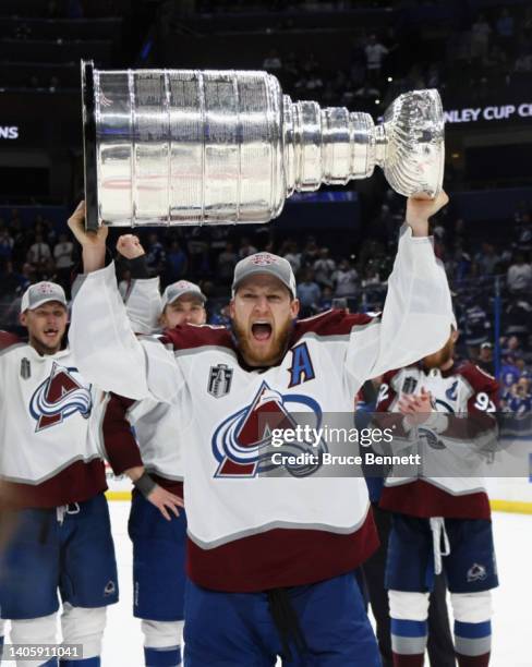 Nathan MacKinnon of the Colorado Avalanche carries the Stanley Cup following the series winning victory over the Tampa Bay Lightning in Game Six of...