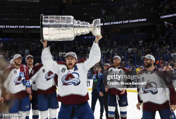 Nathan MacKinnon of the Colorado Avalanche carries the Stanley Cup following the series winning victory over the Tampa Bay Lightning in Game Six of...