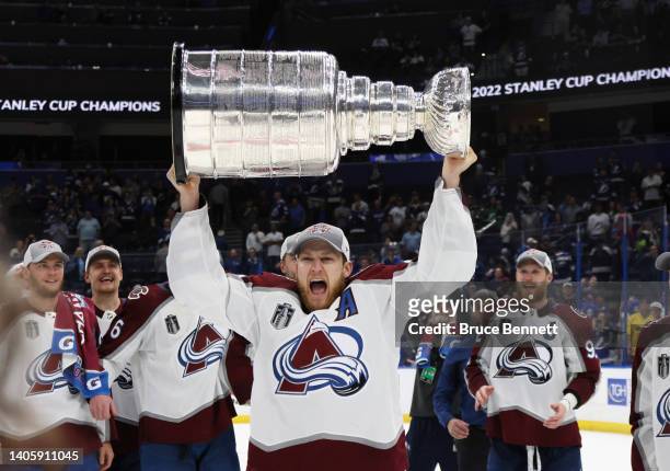 Nathan MacKinnon of the Colorado Avalanche carries the Stanley Cup following the series winning victory over the Tampa Bay Lightning in Game Six of...