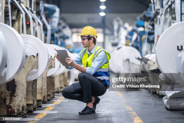 manufacturers engineer and tablet working at plastic bag manufacturers - granule stockfoto's en -beelden