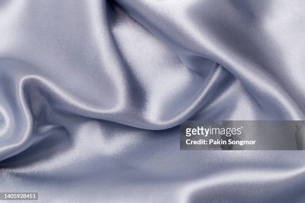 light grayish blue color fabric cloth satin, polyester texture and textile background. - satin stock-fotos und bilder
