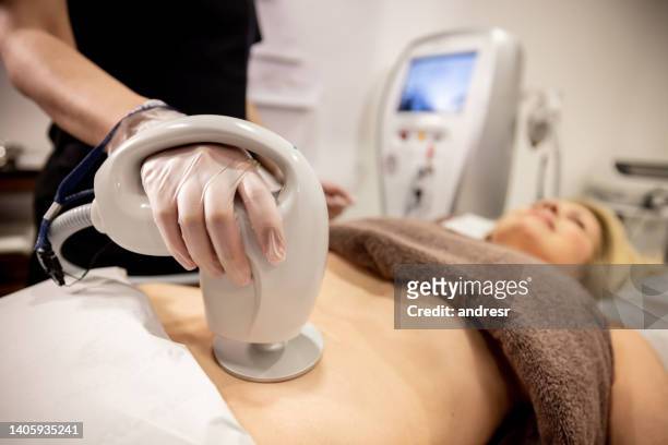woman at a spa tackling her problematic body fat - body stock pictures, royalty-free photos & images
