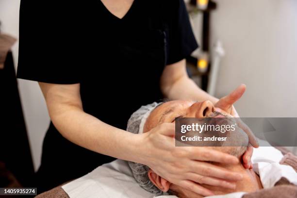 man at the spa getting a facial - doctor scrubs stock pictures, royalty-free photos & images