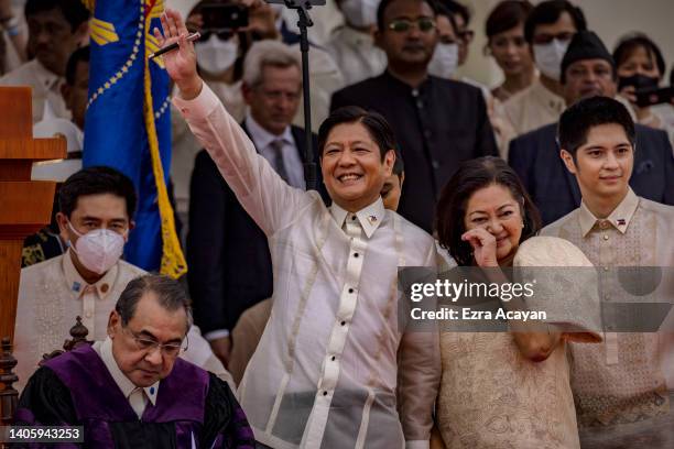 Ferdinand "Bongbong" Marcos Jr. Waves to supporters after taking his oath as the next Philippine President, at the National Museum of Fine Arts on...