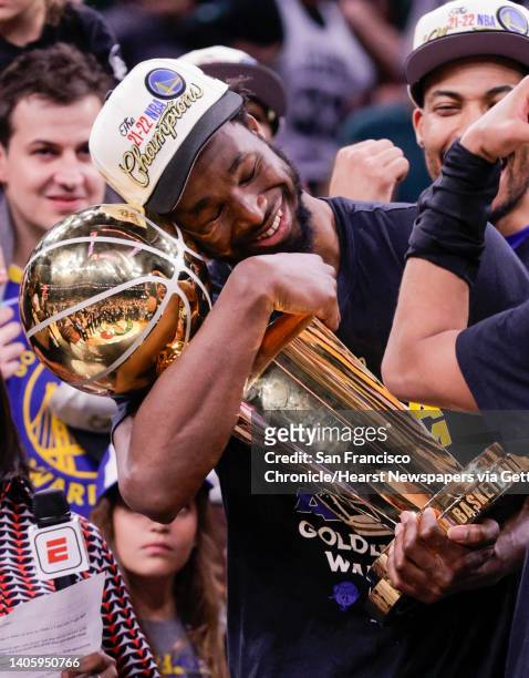 Golden State Warriors' Andrew Wiggins holds the Larry O'Brien Championship Trophy after Game 6 of the NBA Finals at TD Garden in Boston, Mass., on...