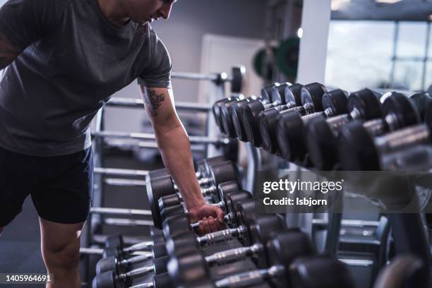 close-up of man's hands taking dumbbell - bodybuilding stock pictures, royalty-free photos & images