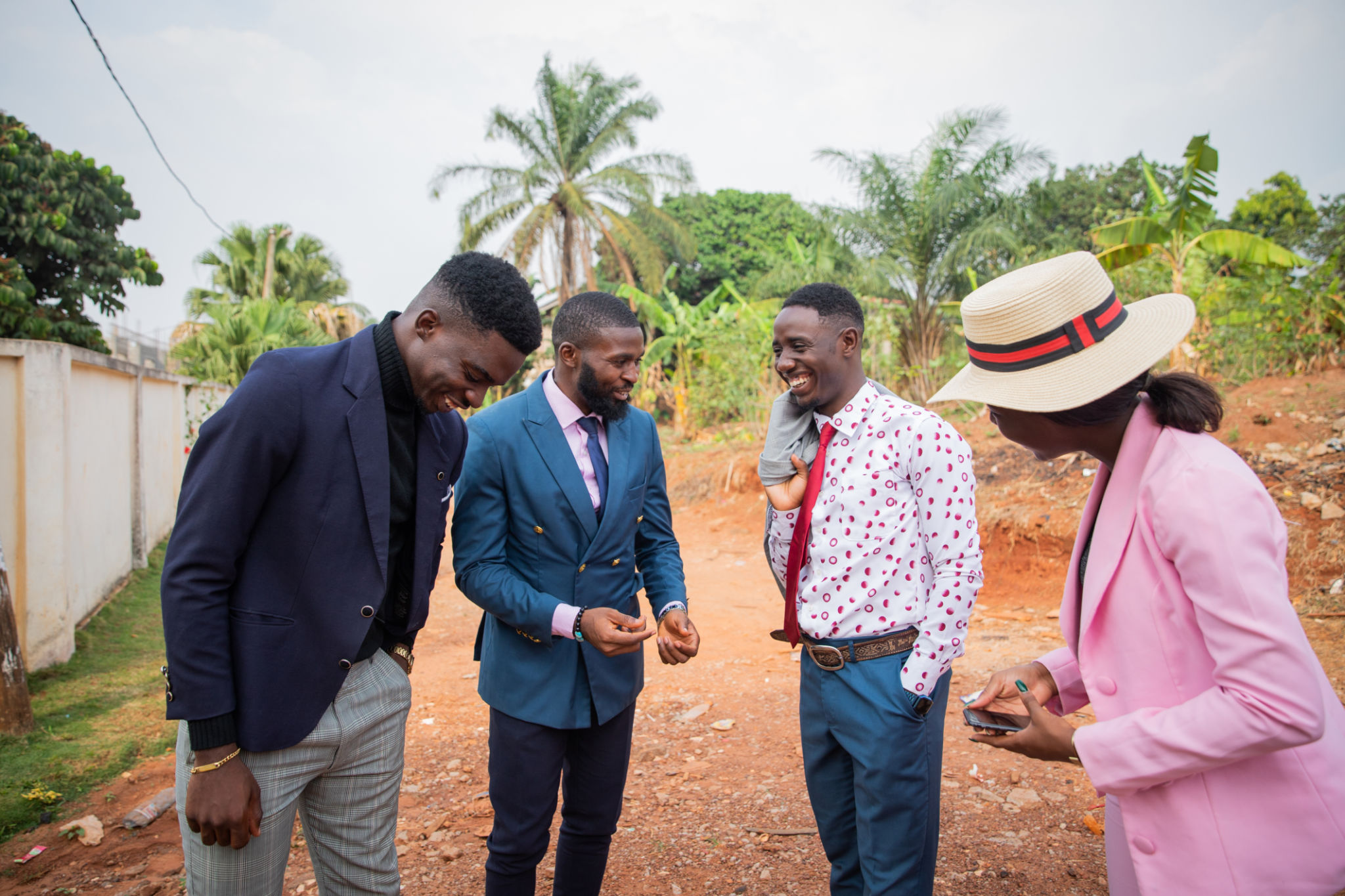 Four business people get together during a meeting to discuss and laugh together, a moment of happiness between well-dressed friends Four business people get together during a meeting to discuss and laugh together, a moment of happiness between well-dressed friends