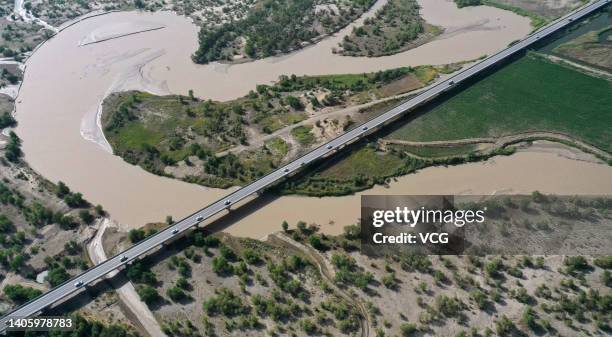 Aerial view of a bridge over the Tarim River, as one part of Yuli-Qiemo Highway, on June 30, 2022 in Bayingolin Mongol Autonomous Prefecture,...