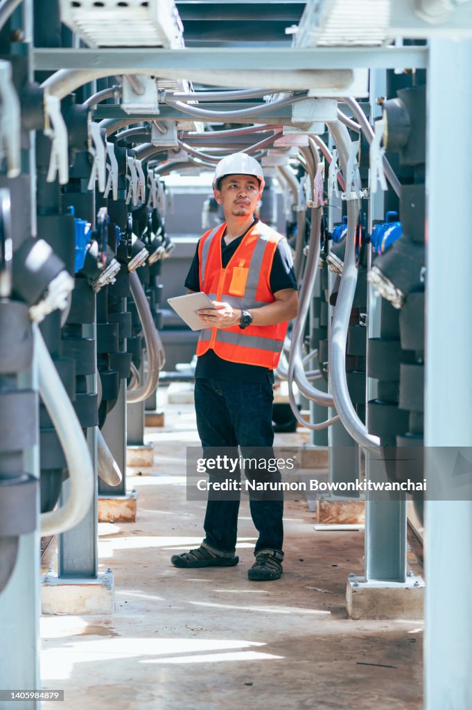 The engineer inspecting the pipeline in the factory