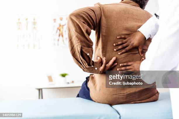 doctor physiotherapist doing healing treatment on man's back - personal injury stockfoto's en -beelden
