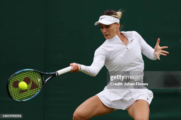 Ana Bogdan of Romania plays a forehand against Petra Kvitova of Czech Republic in their Women's Singles Second Round match on day four of The...