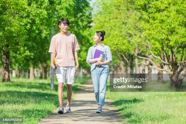 two youths walking while talking - summer university day 2 foto e immagini stock