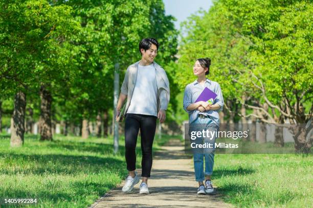 two youths walking while talking - summer university day 2 foto e immagini stock