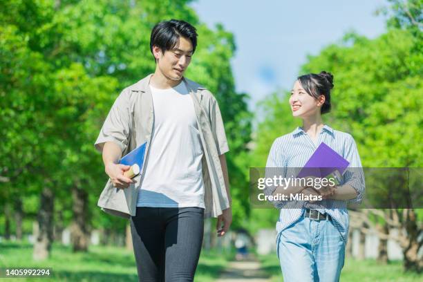 two youths walking while talking - summer university day 2 foto e immagini stock