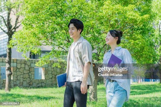 two youths walking while talking - summer university day 2 foto e immagini stock