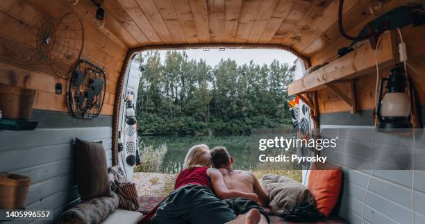 couple enjoying the view from their van - camping couple stock pictures, royalty-free photos & images