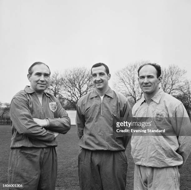 British football manager Alf Ramsey with British footballer Gerry Byrne , and British footballer Jimmy Melia during an England training session ahead...