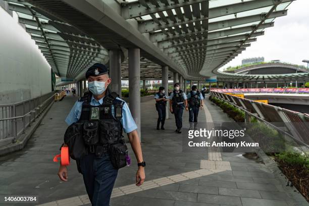 Police officers patrol outside the West Kowloon High Speed Rail Station ahead of President Xi Jinping's arrival on June 30, 2022 in Hong Kong, China....