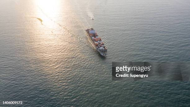 aerial view of cargo ship at sunset - qingdao beach bildbanksfoton och bilder