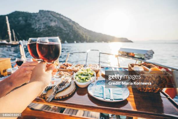 friend drinking wine on the yacht at  sunset. toasting on a yacht. - bateau croisiere photos et images de collection