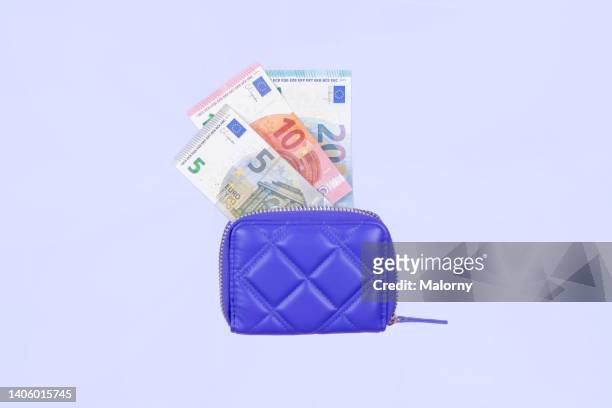 purple wallet with euro banknotes. symbolizing currency rates, purchasing power, inflation etc - wallet money stock pictures, royalty-free photos & images