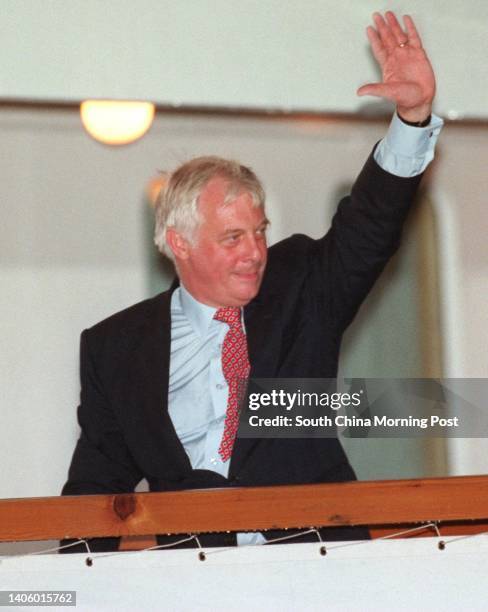 Chris Patten, the former Governor of Hong Kong, waves as he boards the Royal Yacht HMY Britannia to sail from Hong Kong in the early hours after the...