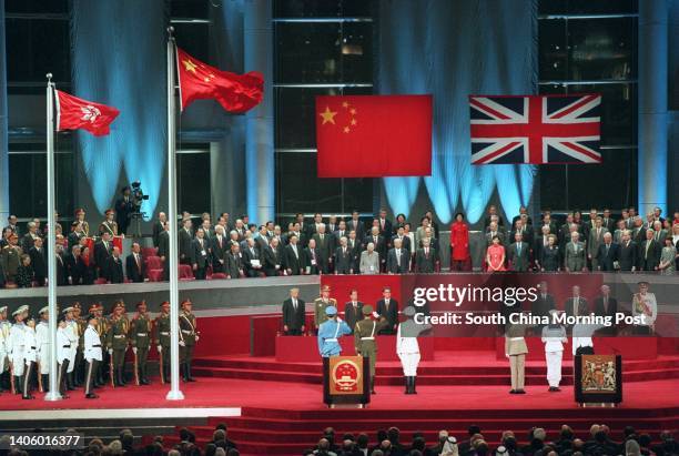 Dignitaries including Jiang Zemin, Li Peng, Tung Chee-Hwa, Prince Charles, Tony Blair, Robin Cook and Chris Patten, receive a salute at the Hong Kong...