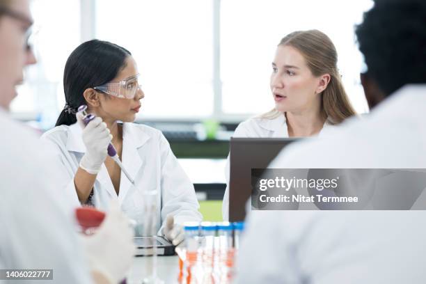 scientific discussion and result. diverse of lab technician team is meeting or discussing results data of e coli bacteria in laboratory. - solutions chemistry stock pictures, royalty-free photos & images