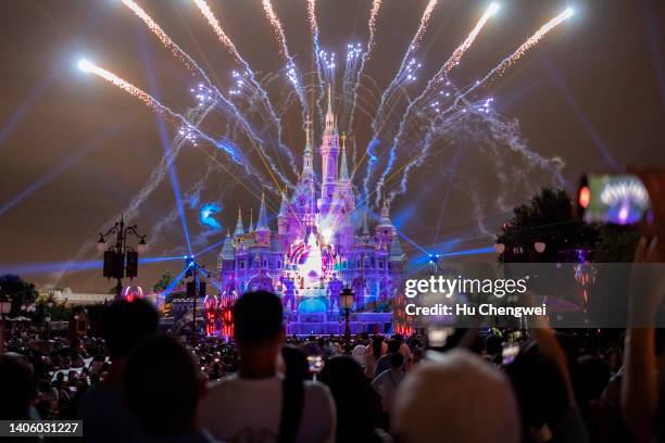 People attend the night show of the Enchanted Storybook Castle at Shanghai Disneyland on June 30, 2022 in Shanghai, China.