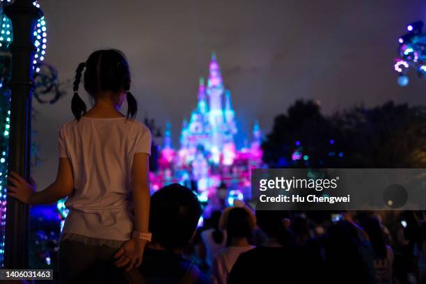 People attend the night show of the Enchanted Storybook Castle at Shanghai Disneyland on June 30, 2022 in Shanghai, China.