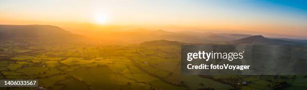 aerial panorama over picturesque rural landscape golden sunset misty mountains - welsh culture imagens e fotografias de stock