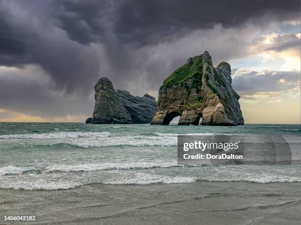 wharariki beach and archway islands view, golden bay, south island, new zealand - tasman stock pictures, royalty-free photos & images