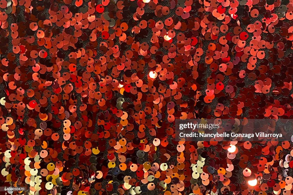 Multi Shades of Red and Orange Sequins on a Fabric