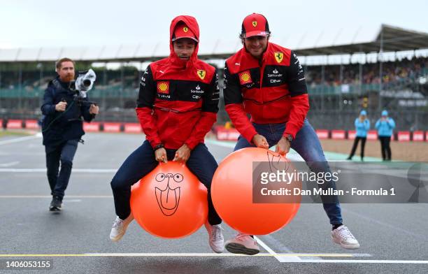 Carlos Sainz of Spain and Ferrari and Charles Leclerc of Monaco and Ferrari race space hoppers on the grid during previews ahead of the F1 Grand Prix...