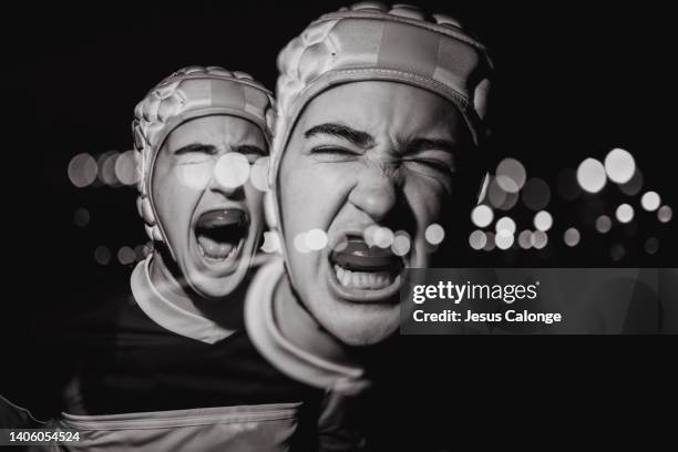 woman, rugby player, with rugby head gear. with her mouthpiece in mouth. rugby, female sport, contact sports concept. style of photography with red lighting. double exposure. black and white image - rugby esporte stock pictures, royalty-free photos & images