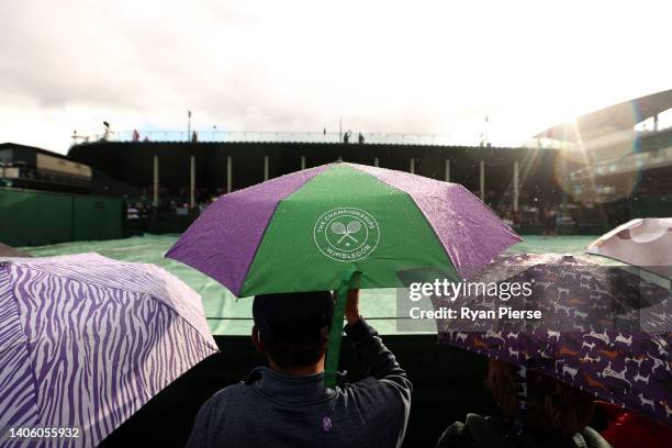 Detail view of "The Wimbledon Championships" logo on an umbrella during rain on day four of The Championships Wimbledon 2022 at All England Lawn...