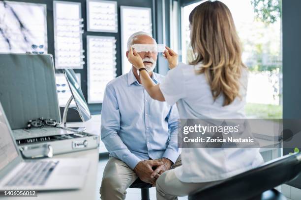 senior at ophthalmologist - conjunctivitis stock pictures, royalty-free photos & images
