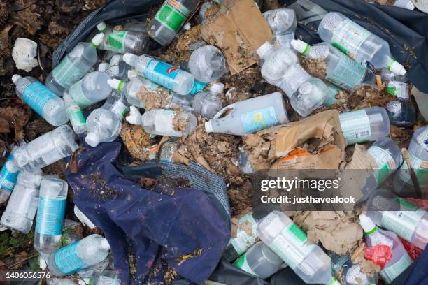 wild garbage with full saline solution bottles - saline stock pictures, royalty-free photos & images