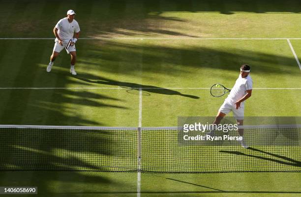 Jonny O'Mara plays a forehand with partner Ken Skupski of Great Britain against Julio Peralta and Alejandro Tabilo of Chile during their Men's...