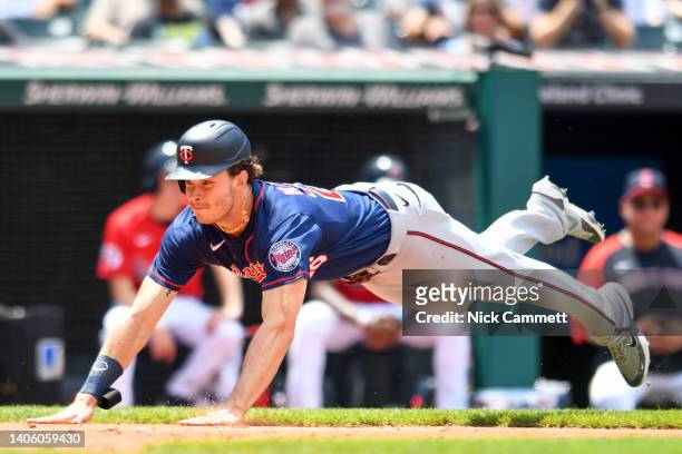 Max Kepler of the Minnesota Twins scores on a three-run double by José Miranda during the third inning against the Cleveland Guardians at Progressive...